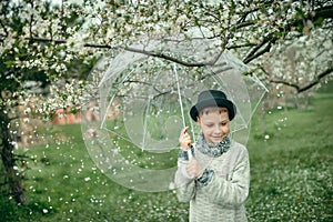 Boy in a hat with an umbrella