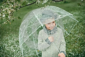 Boy in a hat with an umbrella