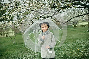 Boy in a hat with an umbrella