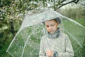 Boy in a hat with an umbrella