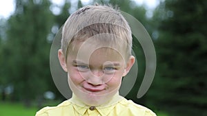 The boy is having fun, first angry, then joyful, laughing. Emotions on the face of the child. Face close-up