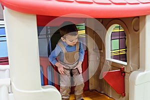 Boy having fun in kids amusement park and indoor play center. Child playing with colorful toys in playground