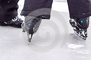 Boy is having fun while skating on natural ice