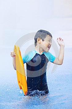 Boy having fun in the swimming pool, water park