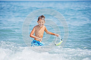 Boy having fun on tropical beach on suuny day photo