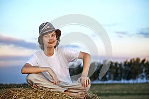 Boy in a haystack in the field