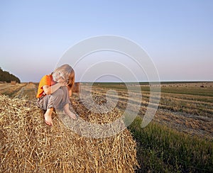 Boy in a haystack in the field