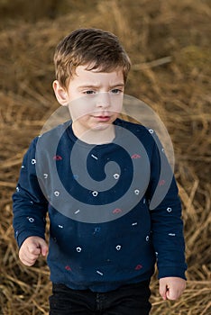 Boy in  haystack portrait