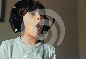 Boy with a headset playing a video game