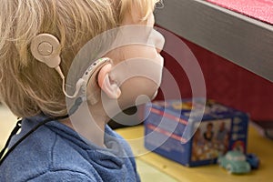 Boy With A Hearing Aids And Cochlear Implants