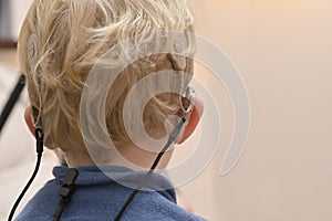 Boy With A Hearing Aids And Cochlear Implants