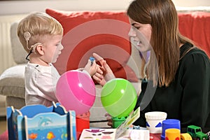 A Boy With A Hearing Aids And Cochlear Implants