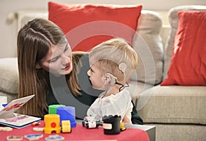 A Boy With A Hearing Aids And Cochlear Implants photo