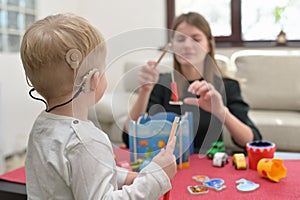A Boy With A Hearing Aids And Cochlear Implants photo