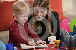 A Boy With A Hearing Aids And Cochlear Implants Playing