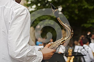 A boy helds a saxophone at a concert