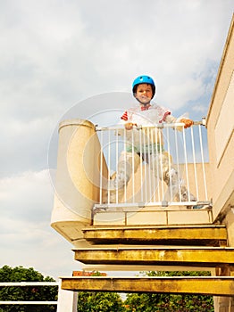 Boy in helmet, bubble wrap near stairs safe door