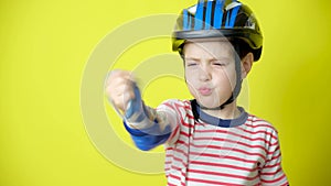 A boy in a helmet, elbow pads and gloves - protection when riding a bicycle, skateboard.