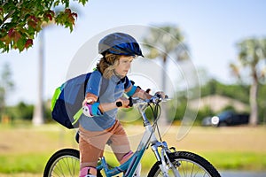 Boy in a helmet riding bike. Boy in safety helmet riding bike in city park. Child first bike. Kid outdoors summer