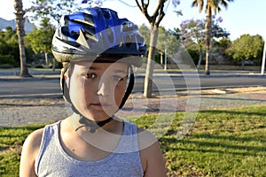 Boy with helmet is riding monowheel on promenade photo