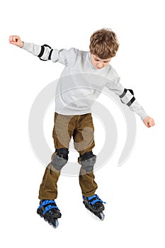 Boy in helmet with at sides and rollerblading