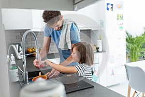 Boy helping father in kitchen