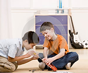 Boy helping friend fix broken toy