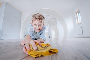Boy helps make cleaning in new apartment after renovation