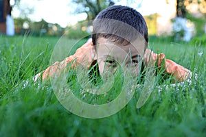 The boy hide in green grass