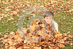 Boy hiding behind leaves