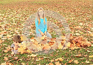 Boy hiding under leaves