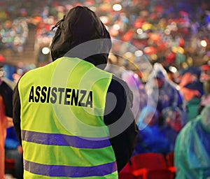 boy with high visibility jacket and  text ASSISTENZA that means photo