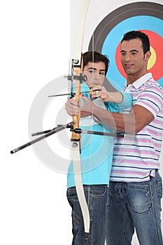 Boy with archery coach photo