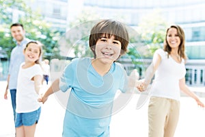 Boy with his family in the background