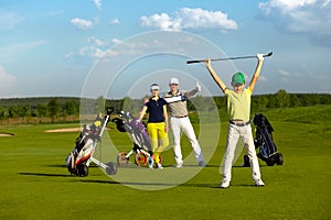 The boy with his family playing golf