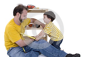 Boy And His Father Building A Storage Cabinet Together