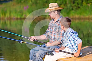 Boy and his father fishing togethe