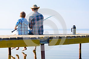 Boy and his father fishing togethe