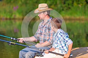 Boy and his father fishing togethe