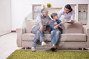 Boy and his father and his grandfother indoor