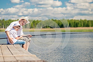 A boy with his father on the weekend on a fishing trip together