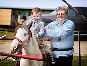 Boy on his First Pony Ride with his Grandmother