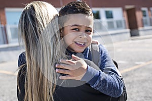 Boy and his mother hugging