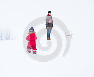 Boy and his mother playing in winter landscape. Child model