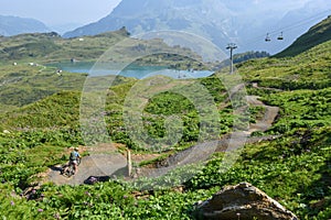 Boy on his mountain bike going down the path from Jochpass