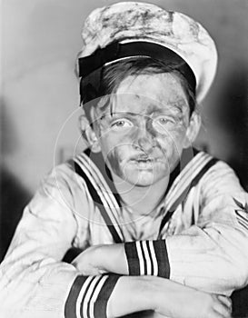 Boy in his sailors outfit with dirty face photo