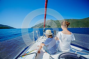 Boy with his sister on board of sailing yacht on summer cruise. Travel adventure, yachting with child on family vacation