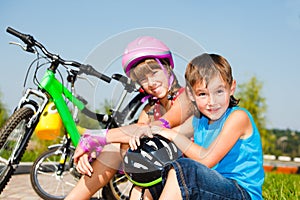 Boy and his sister in protective cycling helmets