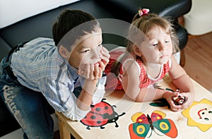 A boy and his sister are watching tv