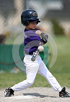Boy hitting baseball